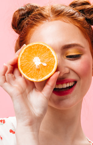 girl holding an orange